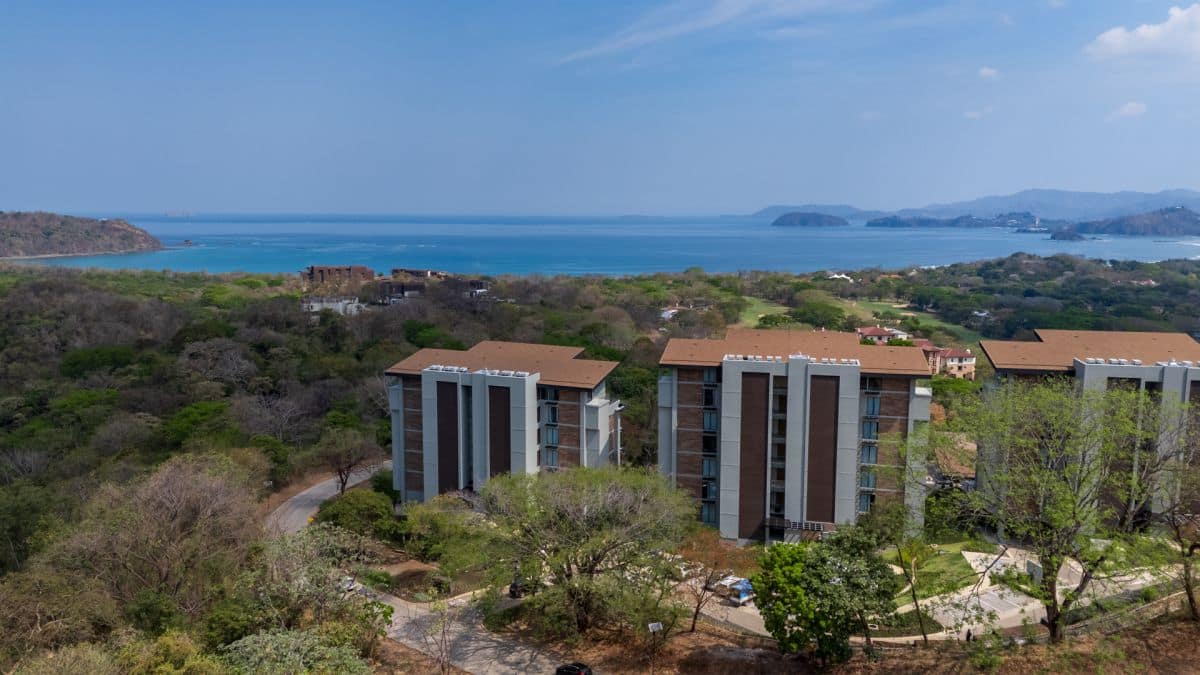 Aerial view of Solaris Acacia 1A in Reserva Conchal, showcasing its prime location with lush tropical surroundings and close proximity to the white-sand beach.