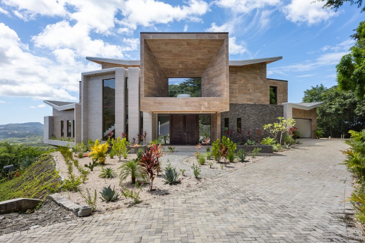 Stunning front view of Casa Manta Ray, showcasing its manta ray-inspired architecture, grand entrance, and modern luxury design.