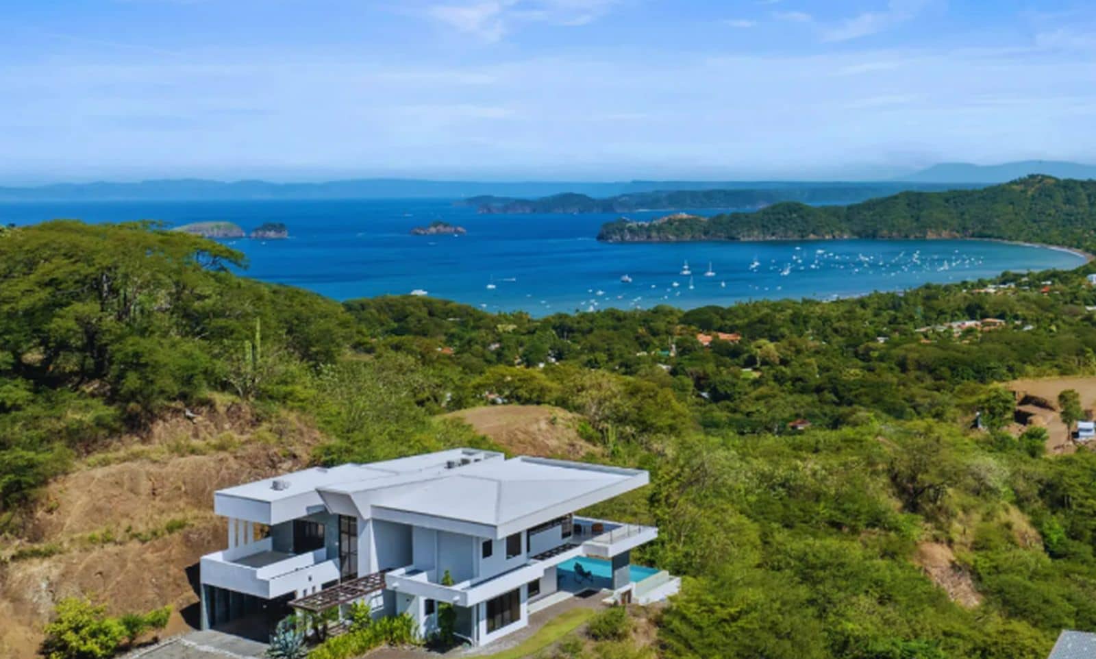 Aerial view of Villa Oceana, a luxury villa in Coco Bay Estates, Playas del Coco, Costa Rica, showcasing its proximity to the beach and stunning tropical surroundings.