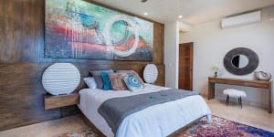 Spacious ocean-view bedroom with custom woodwork and luxurious finishes at Casa Seahorse in Mar Vista, Playa Flamingo.