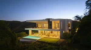 Back view of Villa Oceana featuring an infinity-edge pool, spacious outdoor lounge, and stunning ocean views.