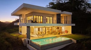 Back view of Villa Oceana featuring an infinity-edge pool, spacious outdoor lounge, and stunning ocean views.