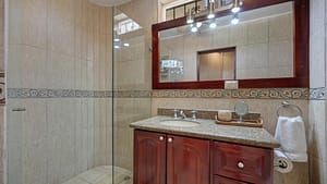 Elegant bathroom with granite vanity and walk-in shower at El Destino 1A beachfront condo in Playa Potrero.