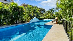 3BR ocean-view condo at Villa Pura Vida, Le Maison Blanche #2 in Altos de Flamingo, Costa Rica. Modern elegance, remodeled kitchen, and stunning views. Gated community, oversized pool, and convenient location near amenities. Fully furnished and turnkey.