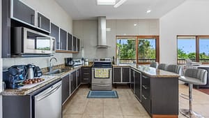 Modern chef’s kitchen with stainless steel appliances and granite countertops at Casa Veranera