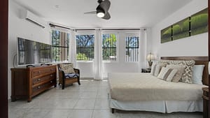 Master bedroom with ocean view, ensuite bathroom, and private terrace access at El Destino 1A, Playa Potrero, Costa Rica.
