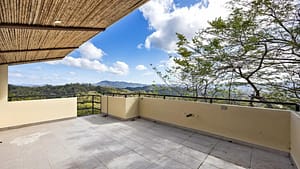 Spacious third-floor terrace with stunning mountain views and a peek-a-boo ocean view, perfect for relaxation.