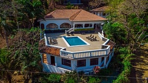 Aerial view of Casa Margarita, a Spanish colonial villa in Playa Flamingo surrounded by tropical greenery