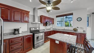 Modern open-concept kitchen with granite countertops and stainless steel appliances at El Destino 1A, Playa Potrero.