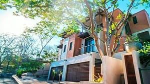 Stunning exterior view of Tamarindo Park #51 luxury home, surrounded by tropical greenery in Playa Tamarindo, Costa Rica.