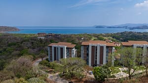Aerial view of Solaris Acacia 1A in Reserva Conchal, showcasing its prime location with lush tropical surroundings and close proximity to the white-sand beach.