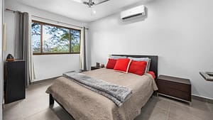Spacious and bright bedroom in the main house with large windows, scenic views, and a cozy ambiance.