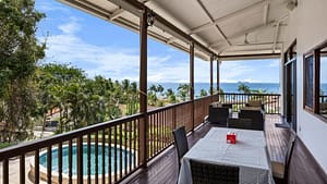 Ocean-view balcony with outdoor seating at Casa Veranera in Playa Flamingo