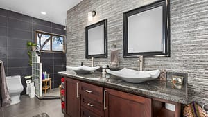 Elegant en-suite bathroom in the main house with modern fixtures, a spacious vanity, and natural light.