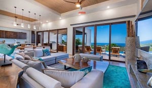 Spacious living room with custom wood furnishings, ocean views, and seamless indoor-outdoor flow at Casa Seahorse in Mar Vista, Playa Flamingo.