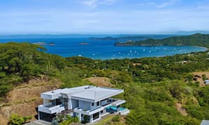Aerial view of Villa Oceana, a luxury villa in Coco Bay Estates, Playas del Coco, Costa Rica, showcasing its proximity to the beach and stunning tropical surroundings.