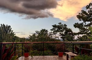 Spacious private balcony with breathtaking views of Arenal Volcano and the lush tropical rainforest, perfect for relaxation and outdoor dining.