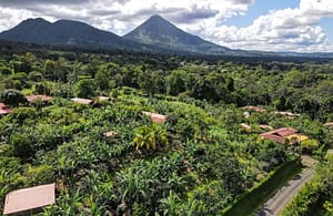 Breathtaking panoramic views of Arenal Volcano and the lush tropical rainforest from a luxury mountain retreat in Costa Rica.