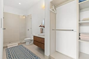 Luxurious bathroom in Villa Oceana with dual vanities, a walk-in shower, and a soaking tub offering elegant tropical design.