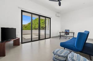 Elegant bedroom at Villa Oceana with ocean views, natural light, and modern tropical design.