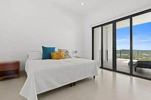 Elegant bedroom at Villa Oceana with ocean views, natural light, and modern tropical design.