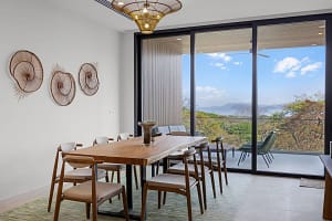 Elegant dining area at Solaris Acacia 1A in Reserva Conchal, featuring a modern table, stylish seating, and an open-concept layout with ocean views.