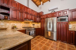 Spacious kitchen with teak wood accents and modern appliances at Casa Margarita, Playa Flamingo