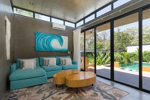 Stylish open-concept living room at Villa Aquarena with modern décor and seamless indoor-outdoor flow.
