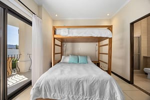 Second bedroom with custom wooden bunk bed and cozy design at Flamingo Towers 11, Playa Flamingo.