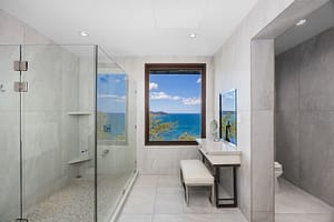 Spa-like bathroom with a glass-enclosed shower, elegant vanity, and ocean views at 360 Splendor del Pacifico Flamingo.