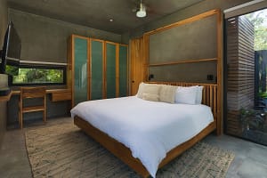 Spacious master bedroom at Villa Aquarena with king-size bed and poolside views