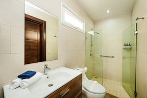 Elegant bathroom at Casa Kenya featuring modern fixtures, a spa-like ambiance, and high-end finishes in Hacienda Pinilla, Costa Rica.