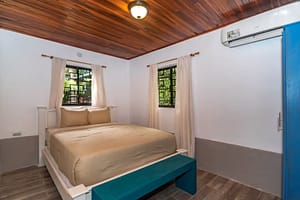 Spacious and elegantly designed bedrooms with panoramic views, queen-size beds, and modern furnishings in a luxury mountain retreat near Arenal Volcano, Costa Rica.