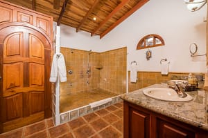 Elegant bathroom with Spanish colonial details and modern fixtures at Casa Margarita, Playa Flamingo