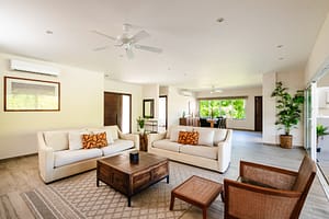 Stylish and spacious living room at Casa Kenya, featuring an open-concept design, high-end furniture, and seamless indoor-outdoor living in Hacienda Pinilla, Costa Rica.