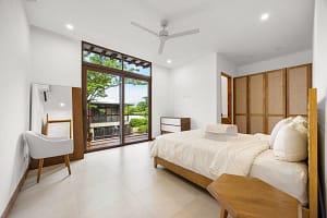 Elegant bedroom with private balcony and modern tropical design at Tamarindo Park #51 in Playa Tamarindo.