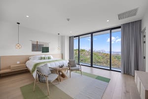 Elegant master bedroom at Solaris Acacia 1A in Reserva Conchal, featuring a king-size bed, modern tropical décor, and breathtaking ocean views.