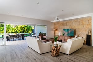 Stylish and spacious living room at Casa Kenya, featuring an open-concept design, high-end furniture, and seamless indoor-outdoor living in Hacienda Pinilla, Costa Rica.