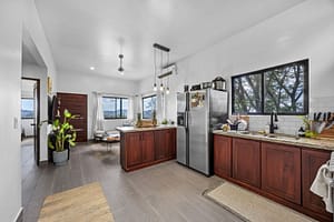 Modern open-concept kitchen in the guest house with sleek countertops, ample storage, and natural light.