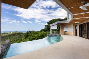 Infinity-edge pool at Casa Manta Ray with panoramic ocean views in Playa Flamingo, Costa Rica.