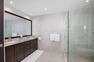 Spa-like bathroom with a glass-enclosed shower, elegant vanity, and ocean views at 360 Splendor del Pacifico Flamingo.
