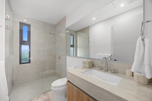 Luxurious bathroom at Solaris Acacia 1A in Reserva Conchal, featuring a spa-like walk-in shower, double vanity, and elegant modern finishes.