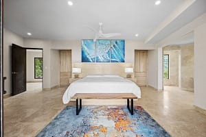 Luxurious bedroom at Casa Manta Ray with ocean views, custom wood furniture, and en-suite bathroom.