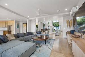 Spacious living room at Casa Manta Ray with ocean views, a 12-seat sectional, and custom wood accents.