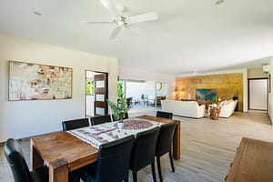 Elegant dining area at Casa Kenya, featuring a spacious open-concept layout, modern furnishings, and seamless indoor-outdoor living in Hacienda Pinilla, Costa Rica.