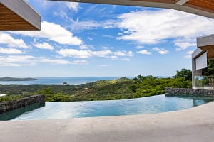 Infinity-edge pool at Casa Manta Ray with panoramic ocean views in Playa Flamingo, Costa Rica.