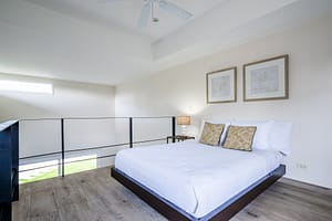 Elegant and spacious bedroom at Casa Kenya, featuring luxurious bedding, modern decor, and serene tropical views in Hacienda Pinilla, Costa Rica.