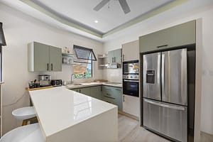 Gourmet kitchen at Casa Camari featuring high-end appliances, custom cabinetry, and a spacious island with ocean views.