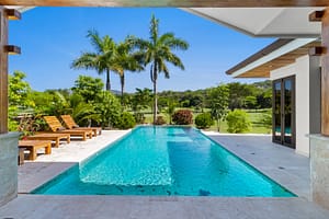 Private swimming pool at Casa Artistica, Reserva Conchal, surrounded by lush greenery and a covered terrace for relaxation and outdoor living.
