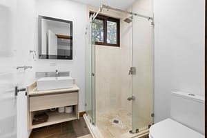 Modern ensuite bathroom at Casa Artistica, featuring elegant finishes, a spacious vanity, and a walk-in shower for a spa-like experience.